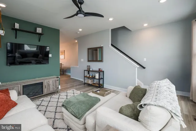 a living room with furniture and a flat screen tv