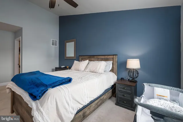 a bedroom with a bed and a lamp