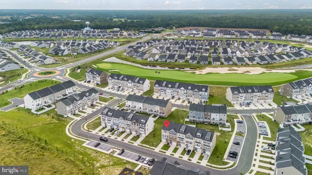 an aerial view of a swimming pool a yard and mountain view in back