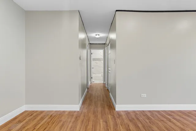 a view of a room with wooden floor