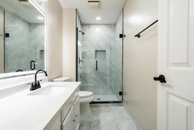 a bathroom with a sink toilet and shower