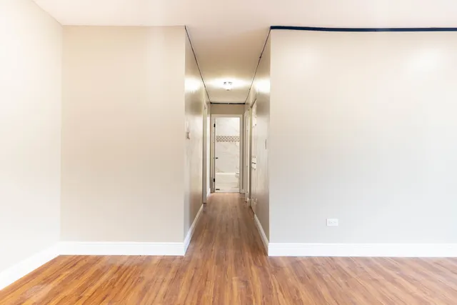 a view of a room with wooden floor