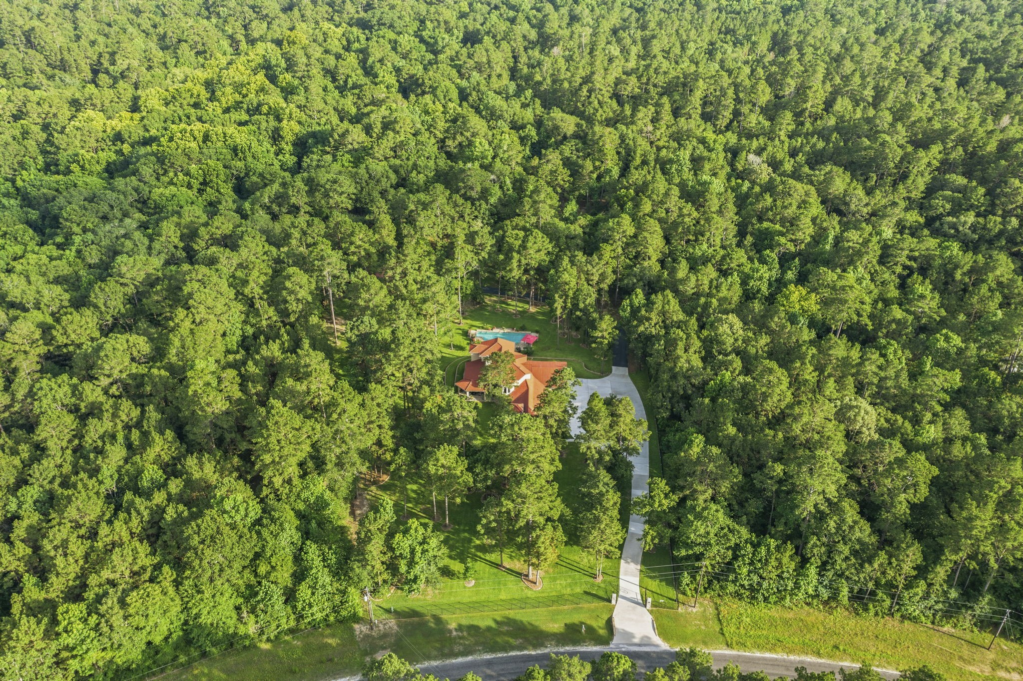280 Sundog Road Huntsville, TX 77340 - Photo 50 of 50 Sweeping aerial view of the property highlights the open grounds and surrounding woods, offering privacy, natural beauty, and a truly special place to call home.
