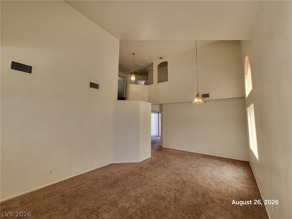 994 Broken Reed Court Henderson, NV 89015 - Photo 4 of 18 High vaulted ceilings and arched windows create a grand sense of space in this interior.