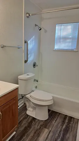 a bathroom with a toilet a sink and a shower