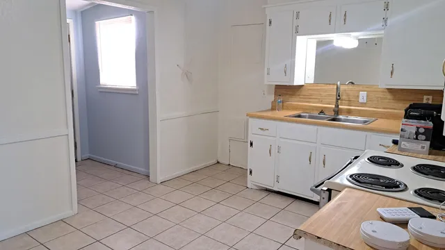 a view of a kitchen with storage and utility