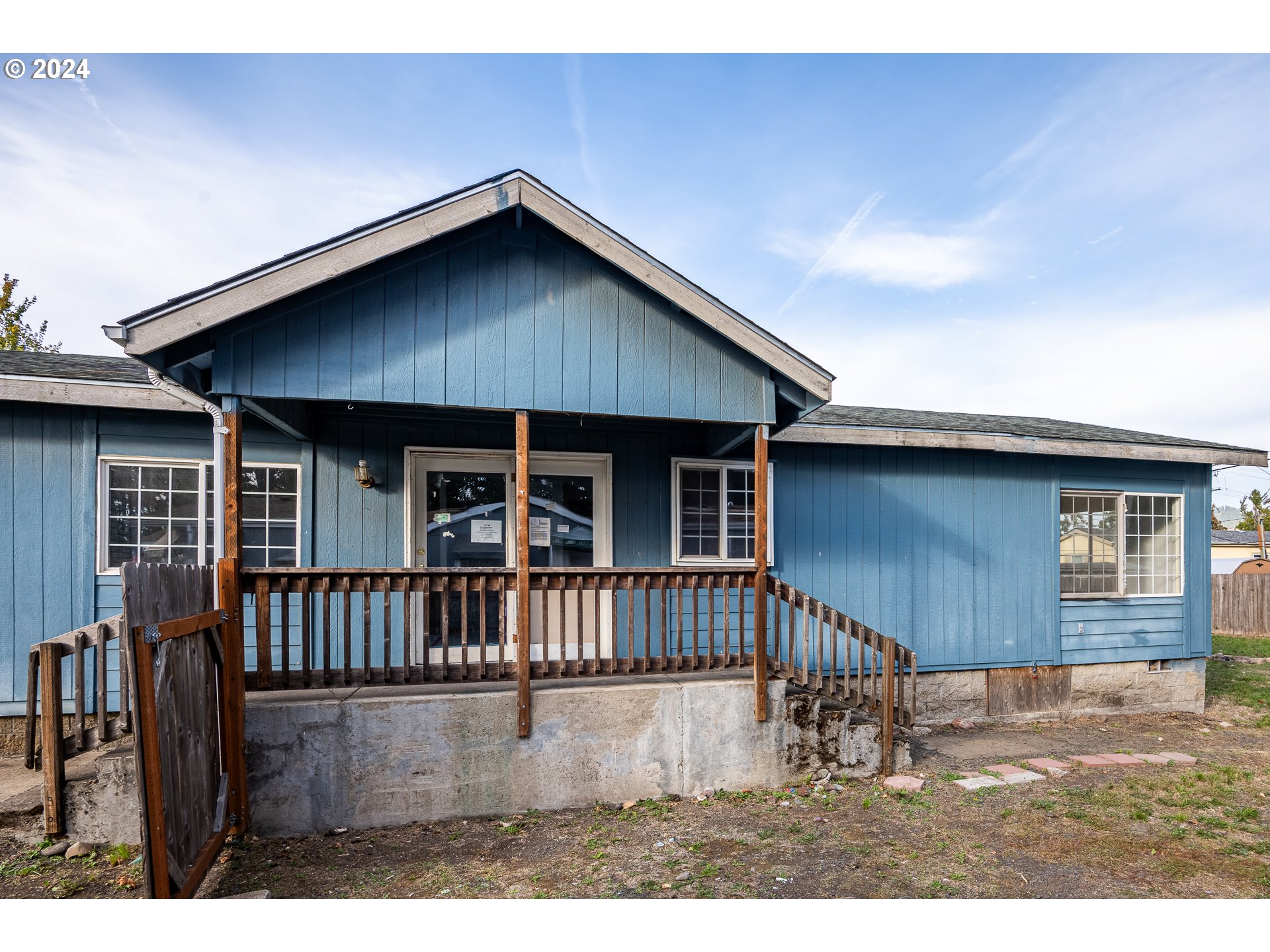 1487 30th Street Springfield, OR 97478 - Photo 4 of 37 a view of a house with wooden deck front of house