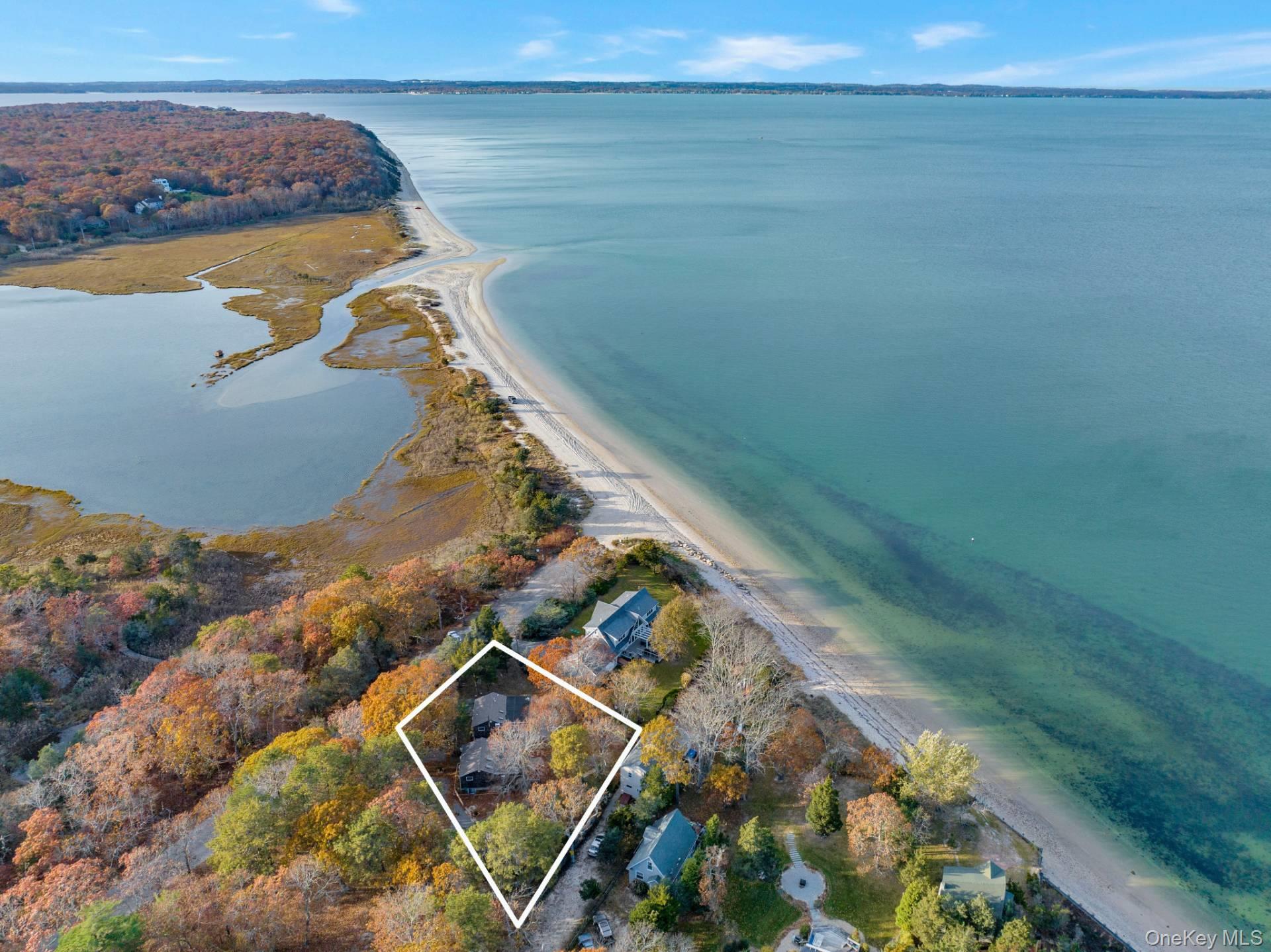 an aerial view of a house with outdoor space lake view and mountain view