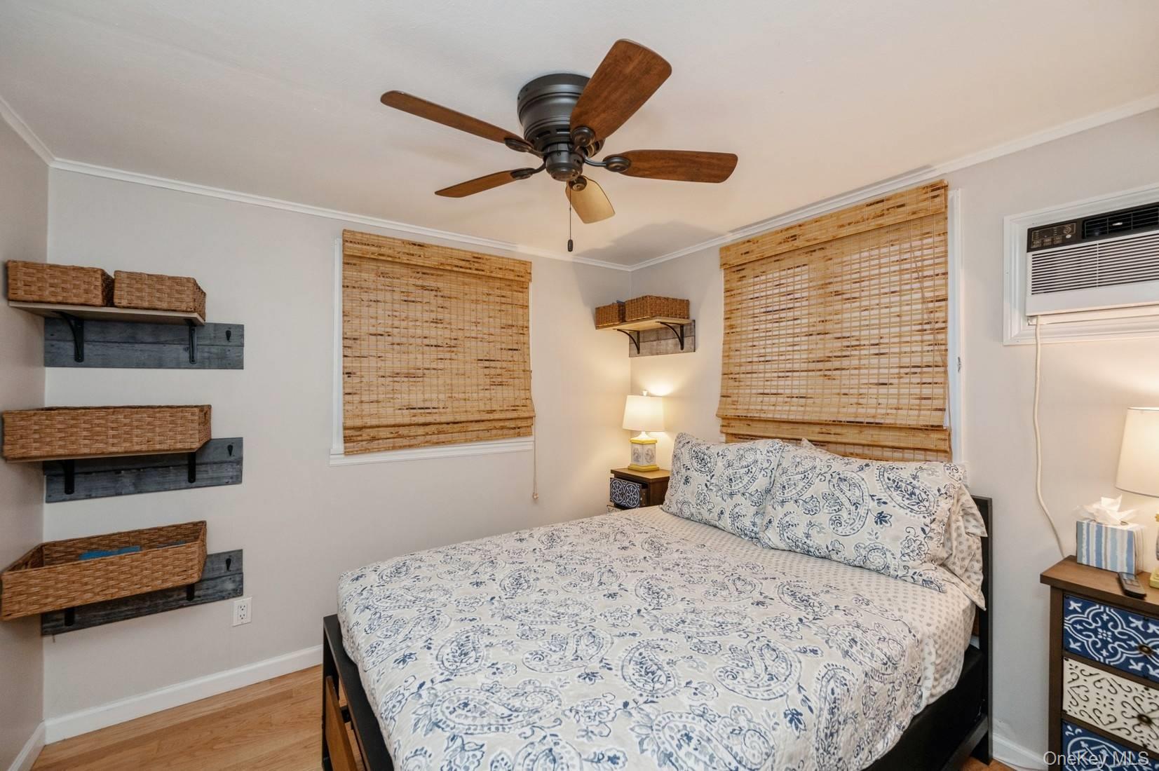 14 East Landing Road Hampton Bays, NY 11946 - Photo 13 of 25 a bedroom with a bed and a window