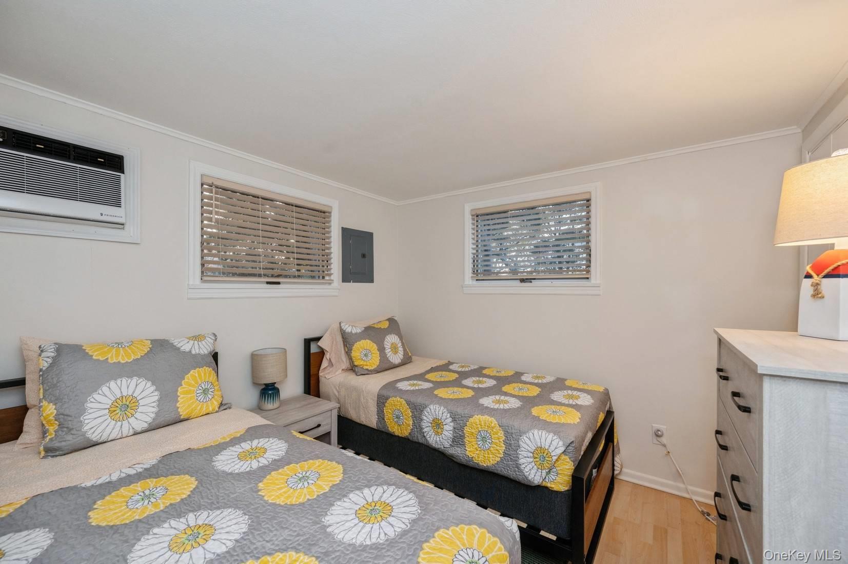 14 East Landing Road Hampton Bays, NY 11946 - Photo 14 of 25 a bedroom that has a bed and a table in it