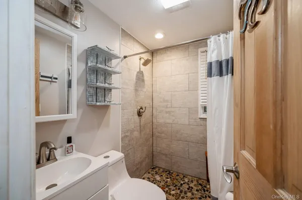 a bathroom with a shower toilet and sink