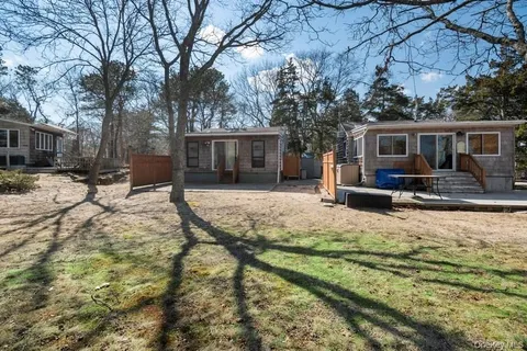a view of a house with a yard covered in snow