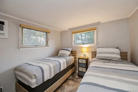 a bedroom with two beds and a window