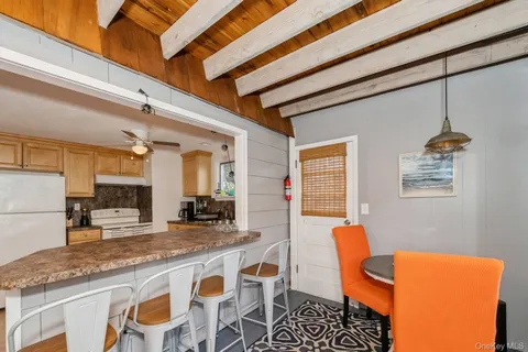 a dining table with chairs and cabinets