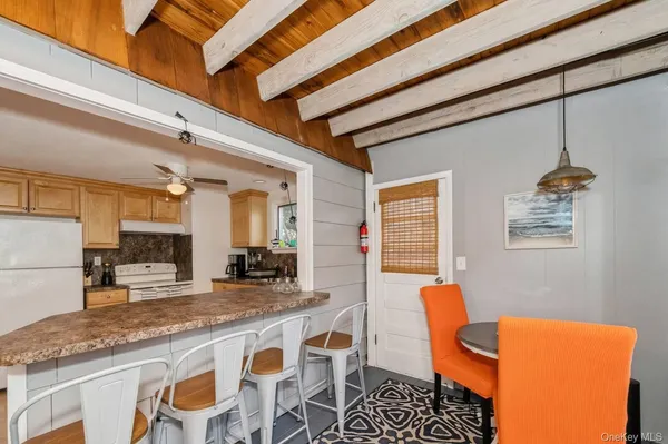 a dining table with chairs and cabinets