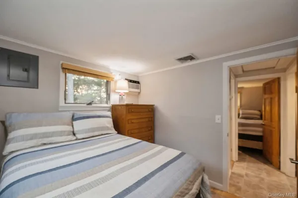 a bedroom with a white bed and a window