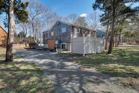 a view of a backyard with large trees