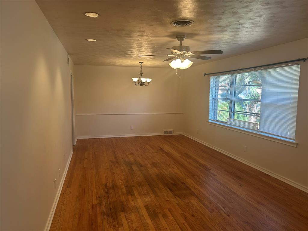 8051 Fall River Drive Dallas, TX 75228 - Photo 2 of 13 an empty room with wooden floor and windows