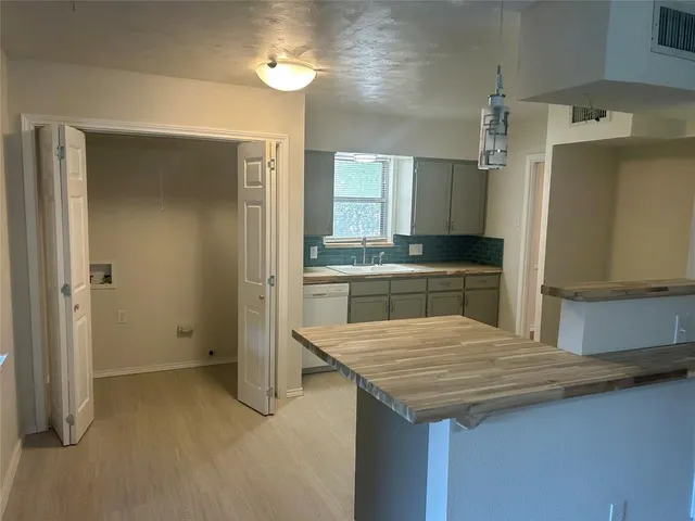 a kitchen with a sink and refrigerator