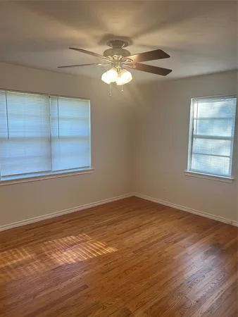 a view of a room with window and wooden floor