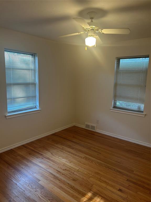 8051 Fall River Drive Dallas, TX 75228 - Photo 10 of 13 a view of empty room with wooden floor and fan