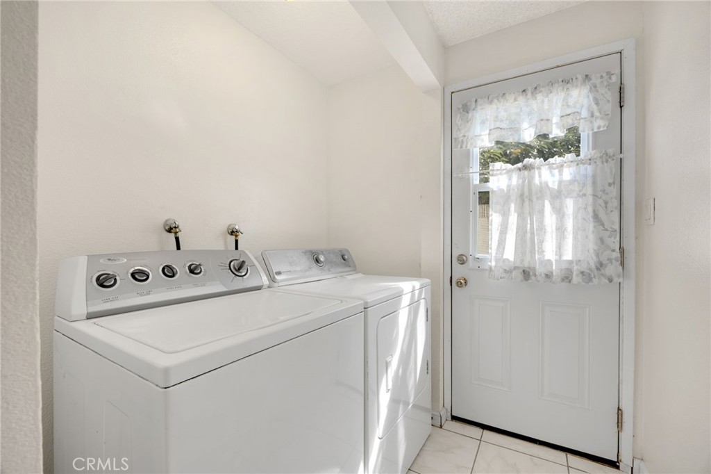 14721 Riata Street Midway City, CA 92655 - Photo 16 of 37 a utility room with dryer and washer