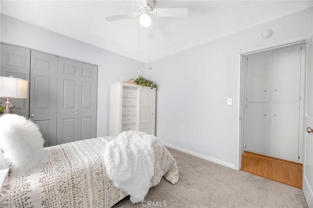 14721 Riata Street Midway City, CA 92655 - Photo 20 of 37 a bedroom with a bed and a chandelier