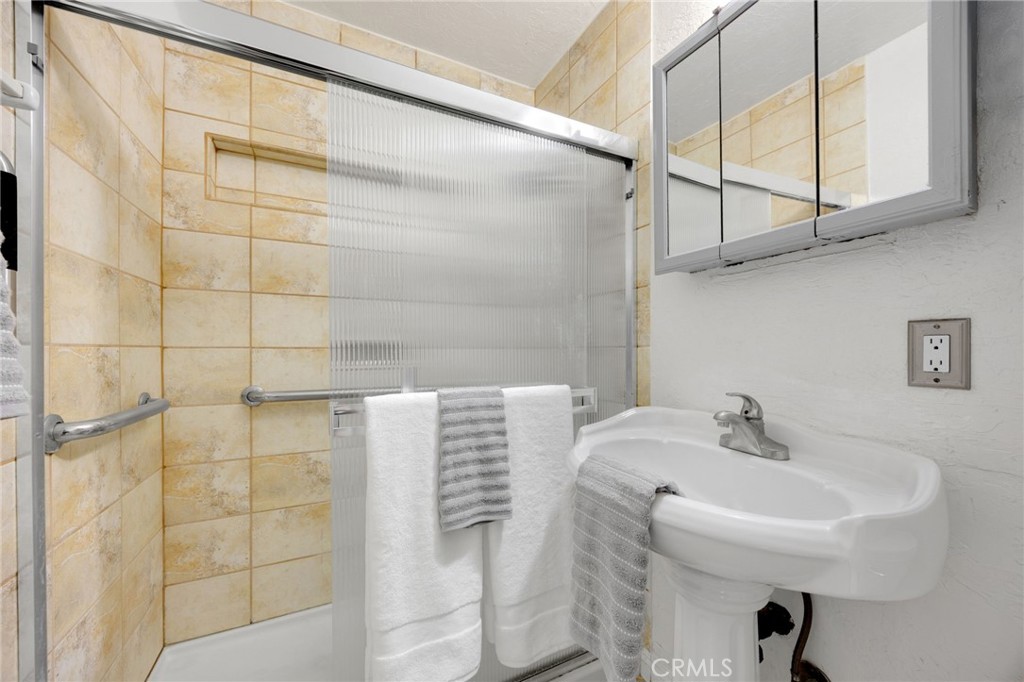 14721 Riata Street Midway City, CA 92655 - Photo 21 of 37 a bathroom with a sink and a shower