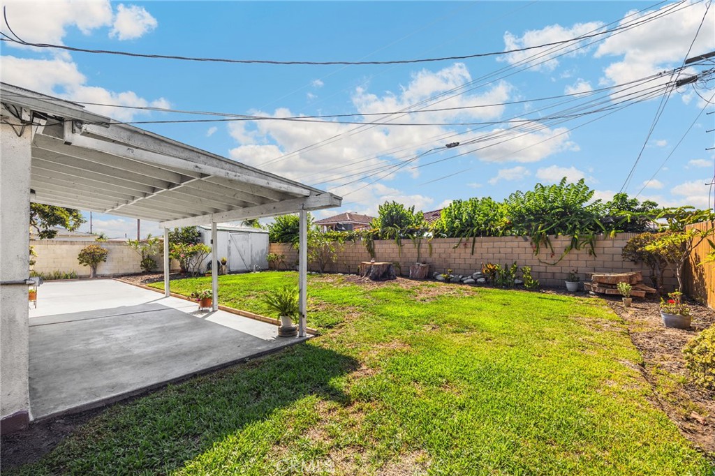 14721 Riata Street Midway City, CA 92655 - Photo 30 of 37 a view of a backyard with plants and a patio
