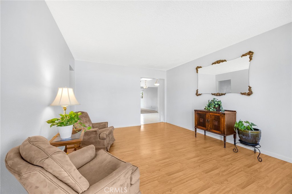 14721 Riata Street Midway City, CA 92655 - Photo 3 of 37 a living room with furniture and a potted plant