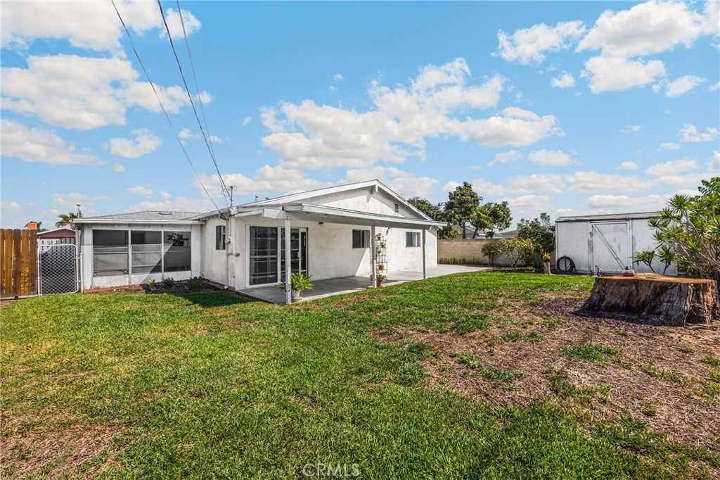 14721 Riata Street Midway City, CA 92655 - Photo 31 of 37 a view of a house with backyard sitting area and garden