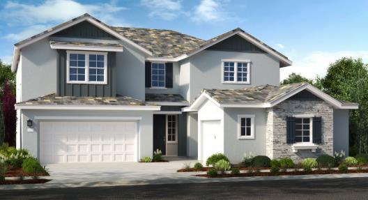 a front view of a house with a garden and plants