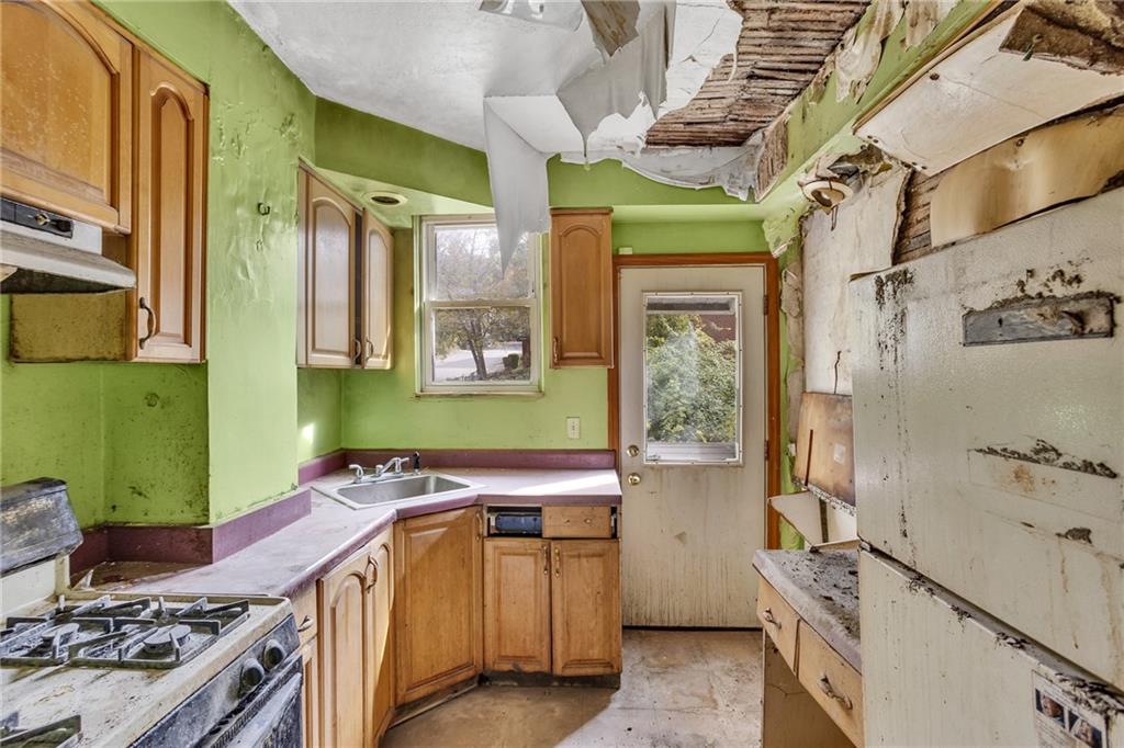 1616 Montier Street Pittsburgh, PA 15221 - Photo 13 of 22 a bathroom with a granite countertop sink a toilet and shower