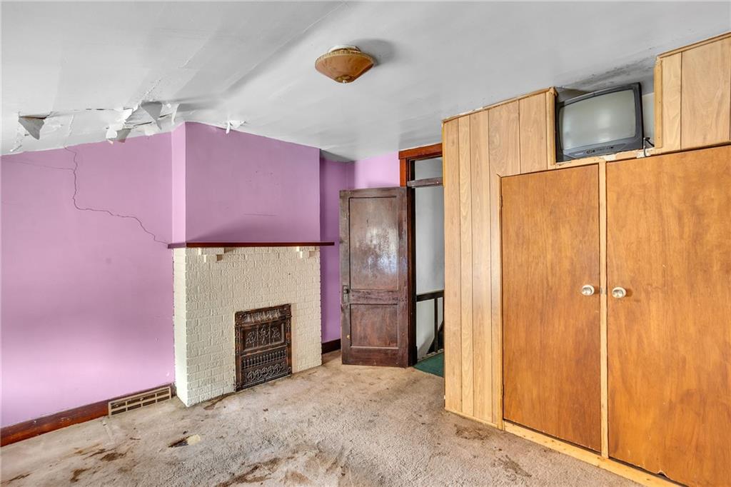 1616 Montier Street Pittsburgh, PA 15221 - Photo 18 of 22 a view of a kitchen with a refrigerator and a fireplace