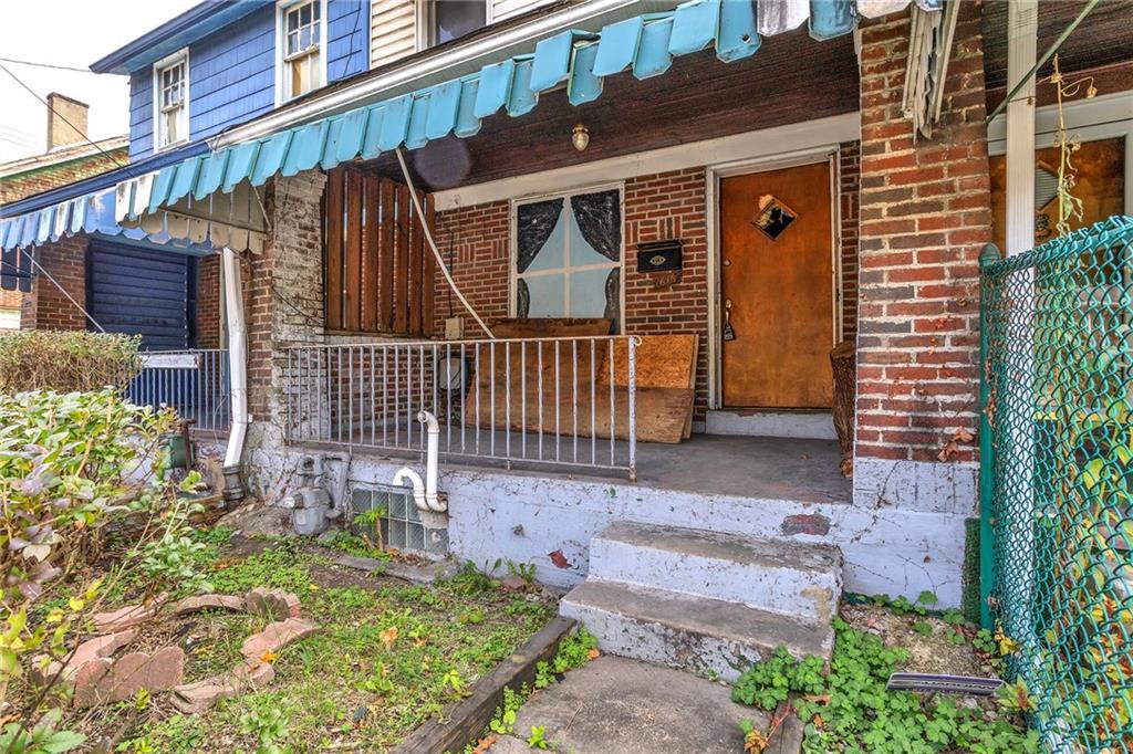 1616 Montier Street Pittsburgh, PA 15221 - Photo 20 of 22 a front view of a house with a yard