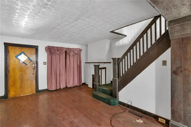 an empty room with closet and a fireplace