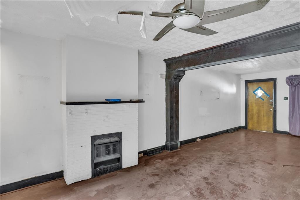 1616 Montier Street Pittsburgh, PA 15221 - Photo 8 of 22 an empty room with closet and a fireplace