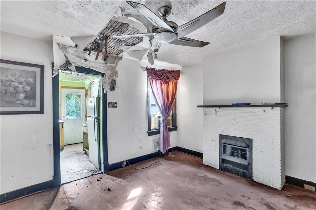 1616 Montier Street Pittsburgh, PA 15221 - Photo 10 of 22 a view of a livingroom with a fireplace cabinet and windows