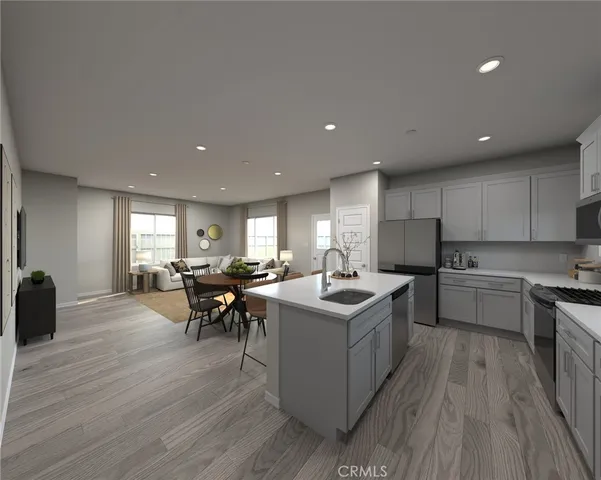 a kitchen with a sink and wooden floor