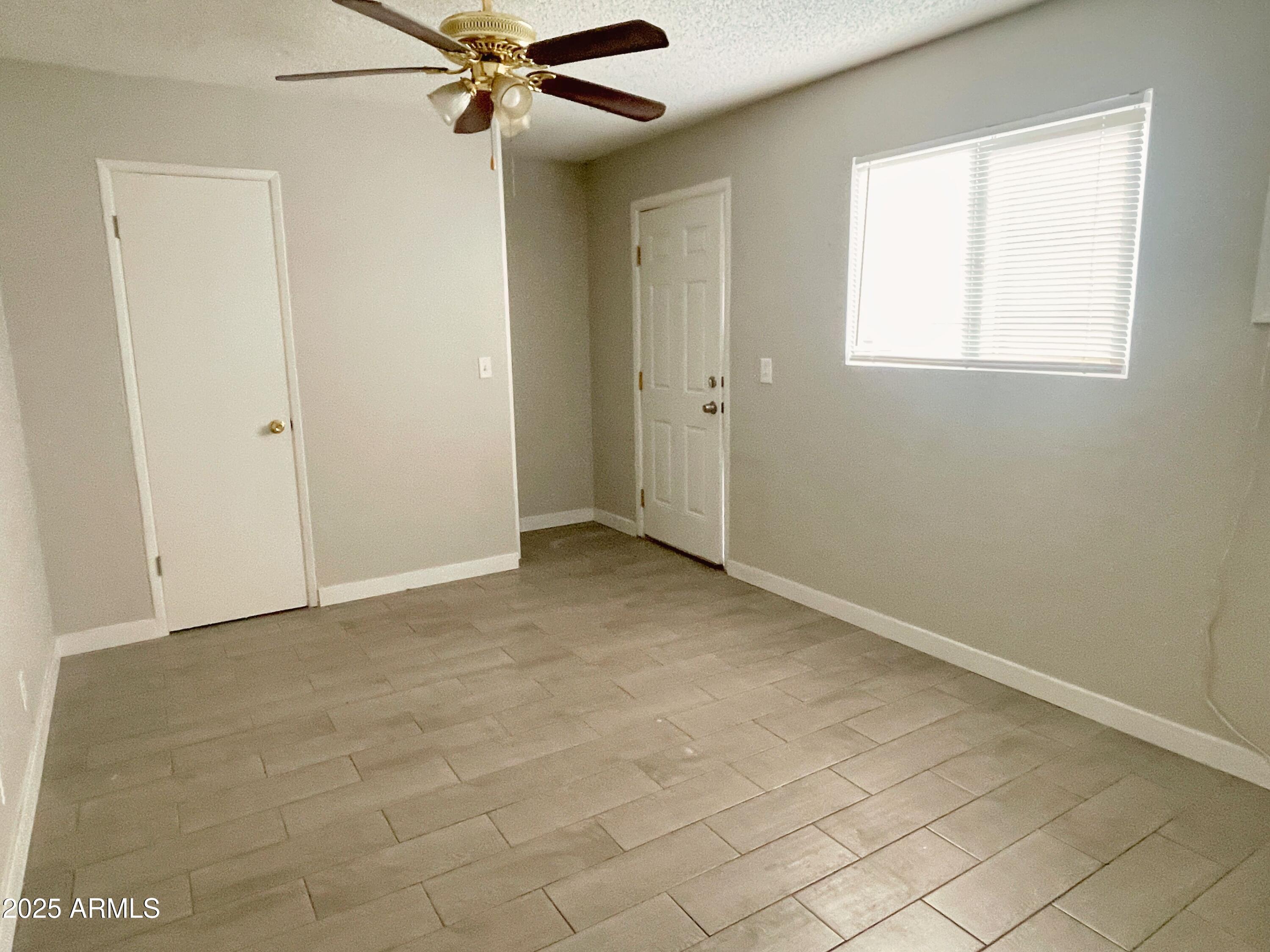 6413 East Avalon Street, Unit E Mesa, AZ 85205 - Photo 4 of 6 an empty room with windows