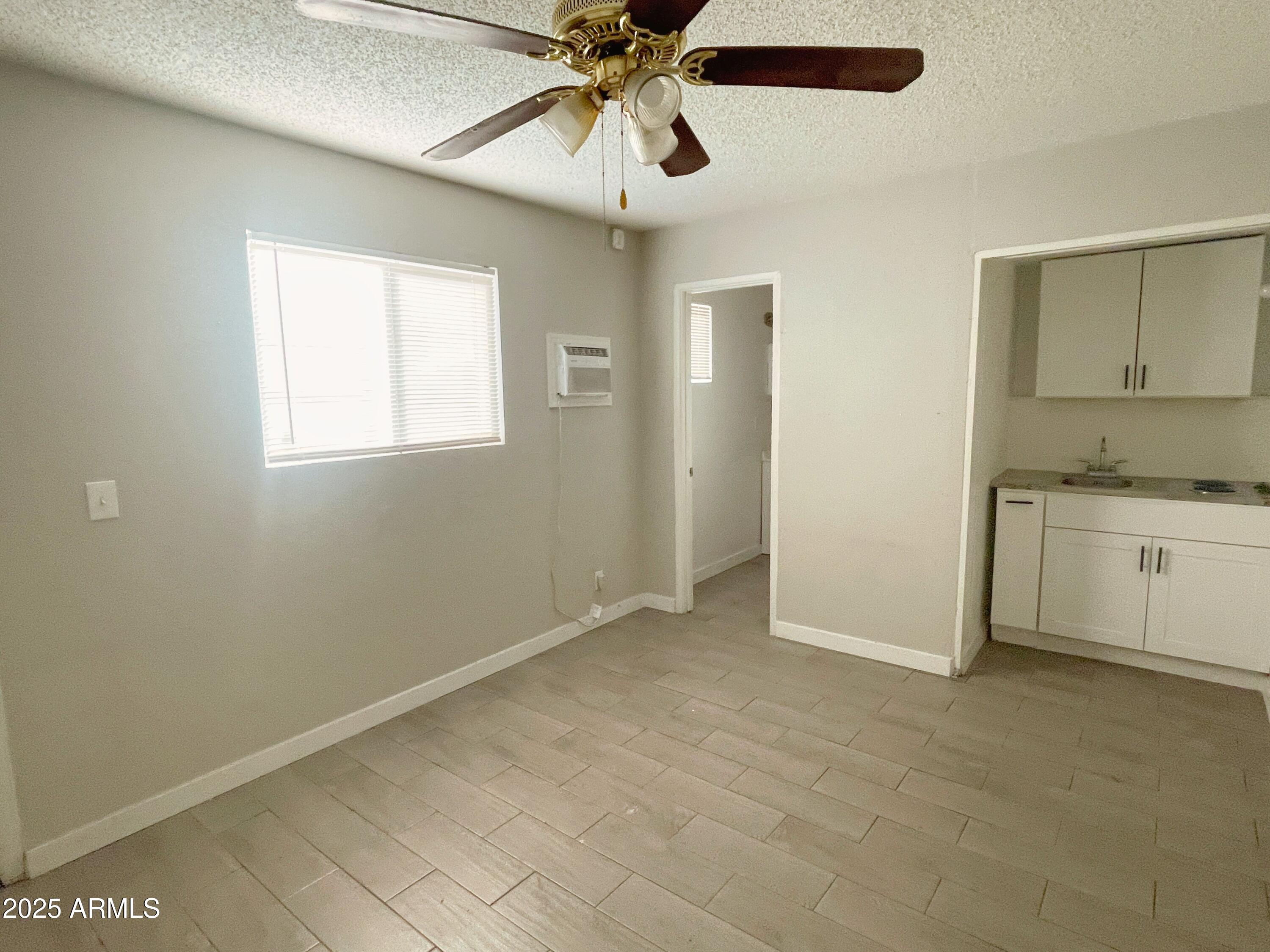 6413 East Avalon Street, Unit E Mesa, AZ 85205 - Photo 5 of 6 a view of a kitchen with a sink and cabinet area