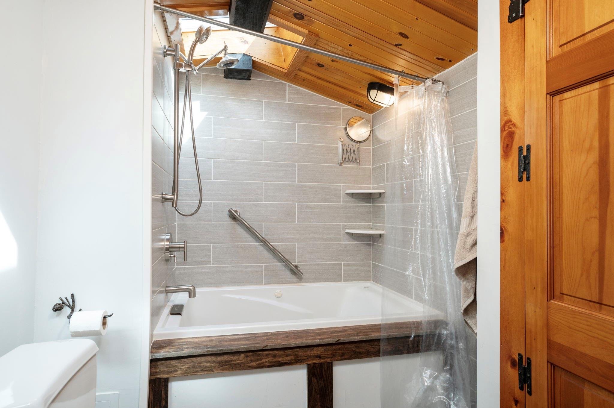 25 Dycus Drive Fairview, NC 28730 - Photo 20 of 30 a bathroom with a bathtub and a shower