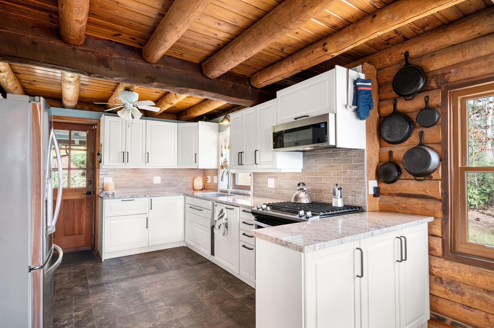 25 Dycus Drive Fairview, NC 28730 - Photo 7 of 30 a kitchen with a stove cabinets and a sink