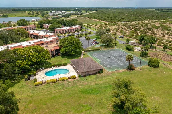 an aerial view of residential houses with outdoor space and river