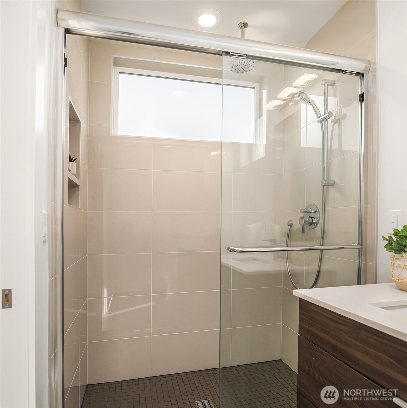 2455 Wickstrom Place Southwest Seattle, WA 98116 - Photo 17 of 36 a bathroom with a glass shower door