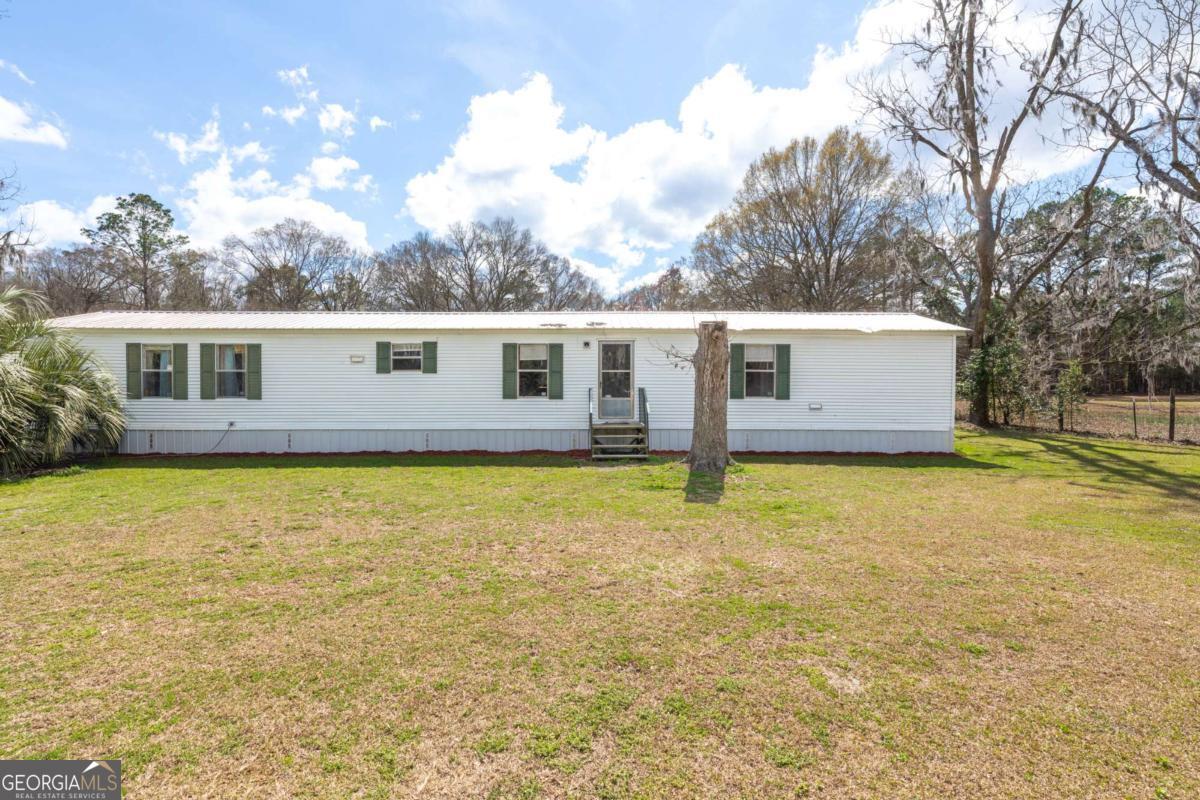 3547 Chapel Lane Blackshear, GA 31516 - Photo 1 of 33 a view of a house with pool and a yard