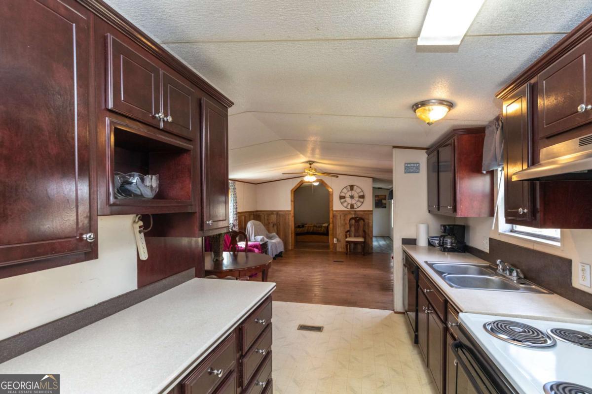 3547 Chapel Lane Blackshear, GA 31516 - Photo 13 of 33 a kitchen with a sink stove and cabinets