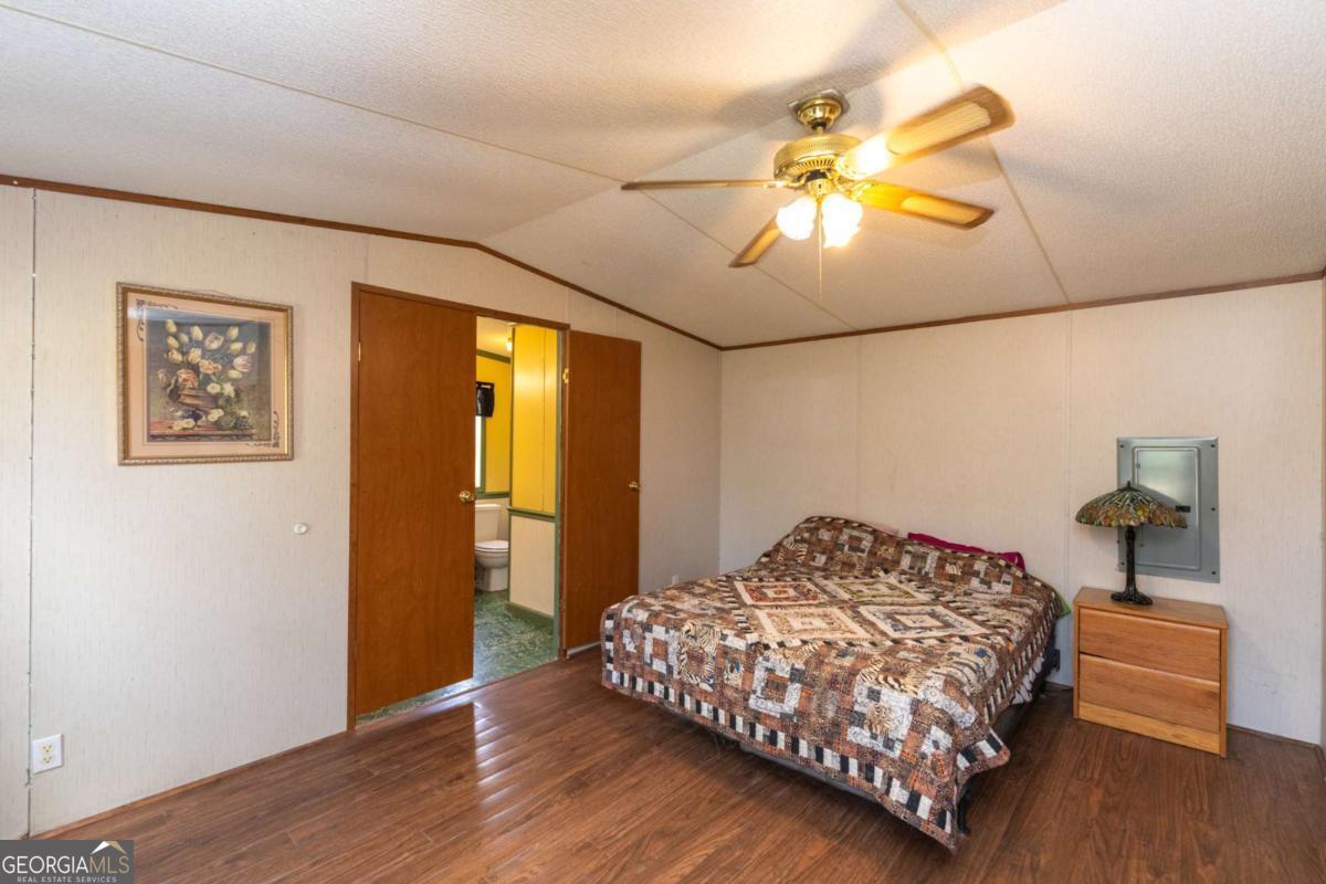 3547 Chapel Lane Blackshear, GA 31516 - Photo 15 of 33 a bedroom with a bed and a window