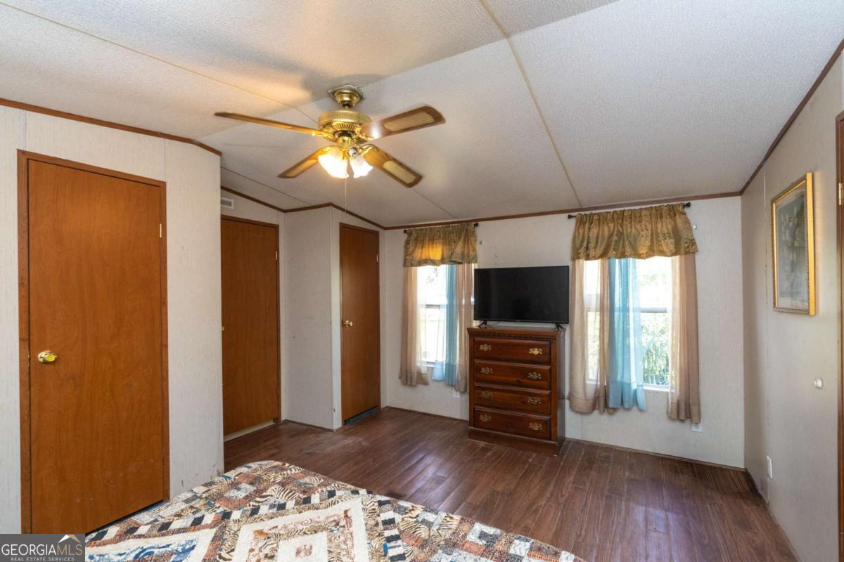 3547 Chapel Lane Blackshear, GA 31516 - Photo 17 of 33 a view of a livingroom with wooden floor and a ceiling fan