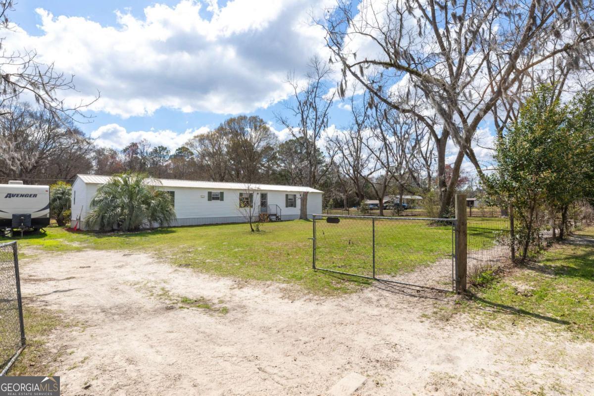 3547 Chapel Lane Blackshear, GA 31516 - Photo 2 of 33 a view of a house with a big yard